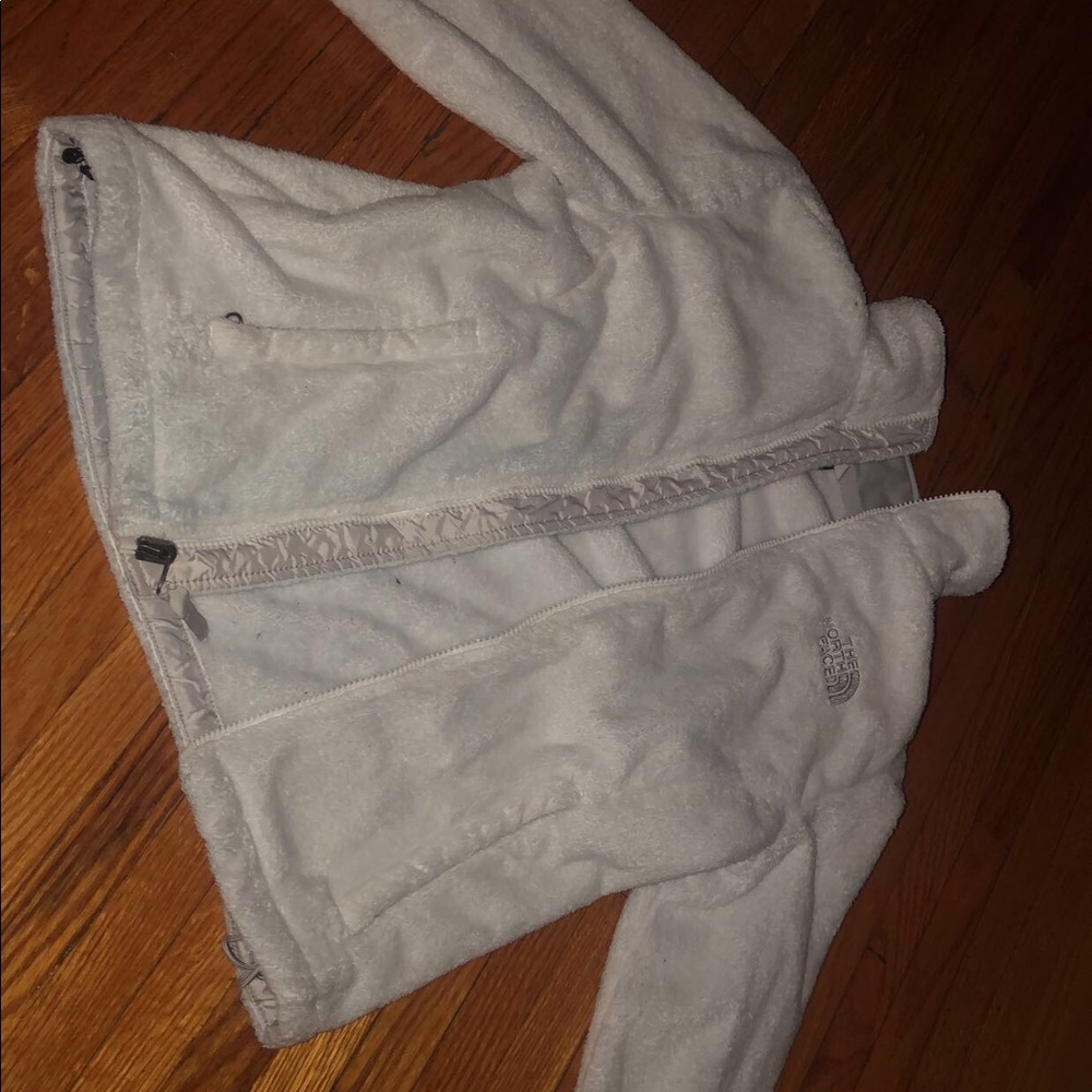 White fuzzy north face jacket